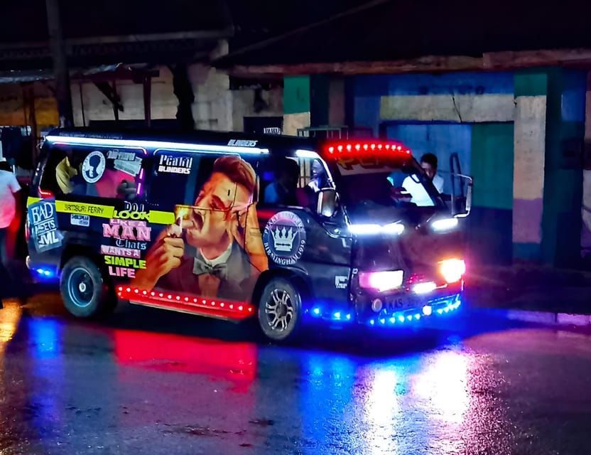 Un minibús brillantemente decorado con luces LED azules y rojas se encuentra en una calle mojada de la ciudad por la noche, sus luces reflejándose en el pavimento.