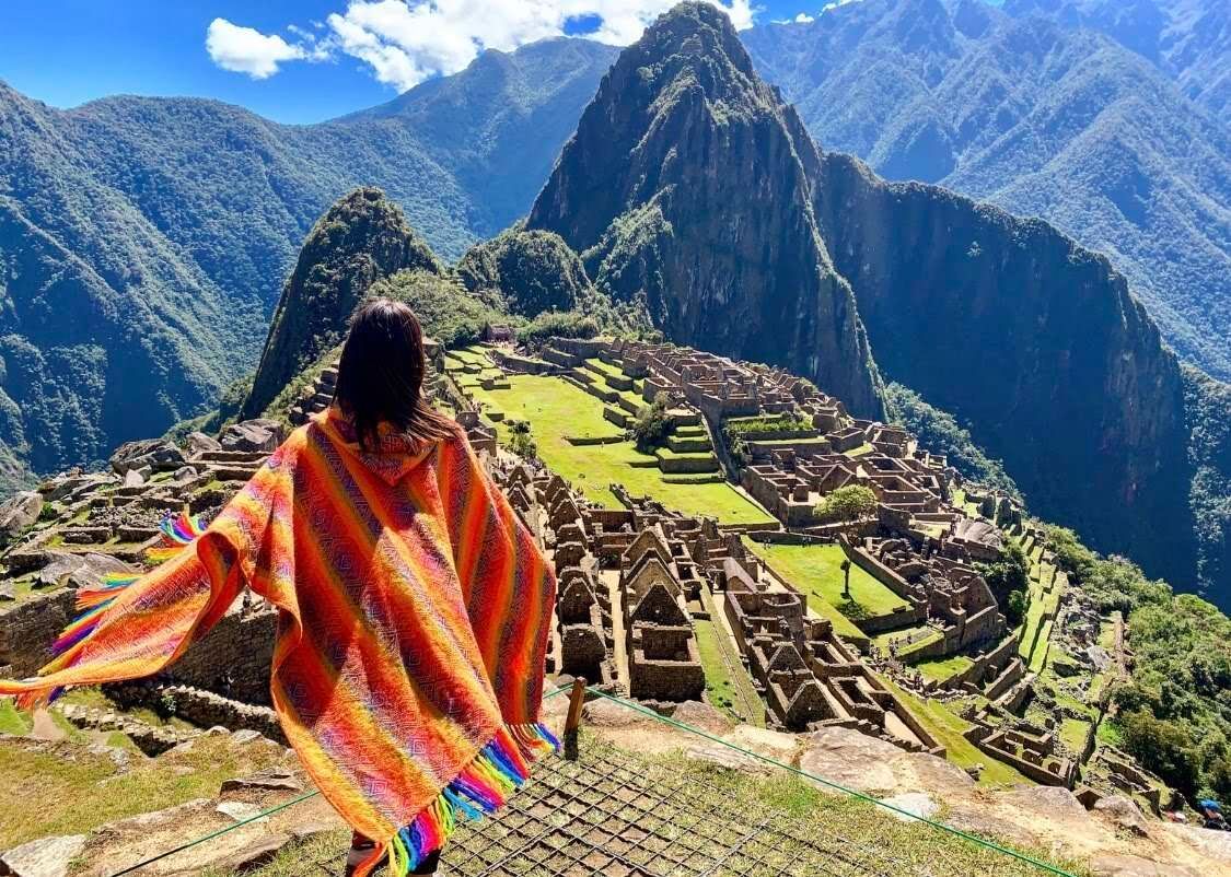 Girl standing in front of Machu Picchu in Peru