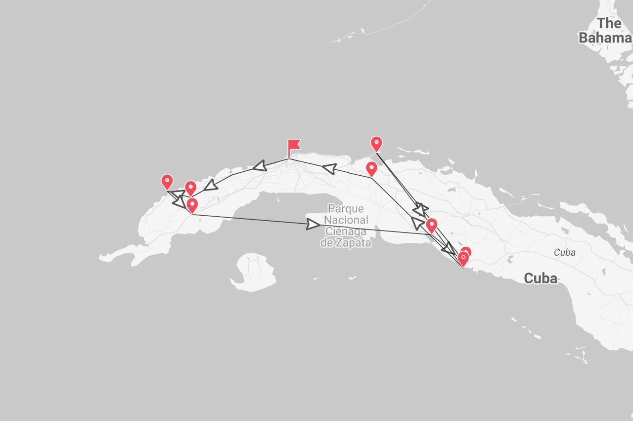 A map of Cuba showing a tour itinerary with red pins and a marked route across the island, with The Bahamas visible to the northeast.