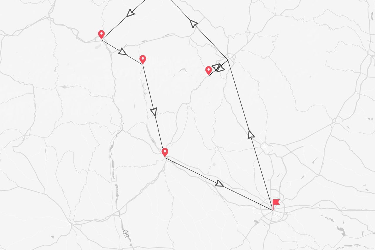Una mappa stilizzata che mostra un itinerario di viaggio, con il percorso indicato da linee e frecce che collegano diversi segnaposto rossi.