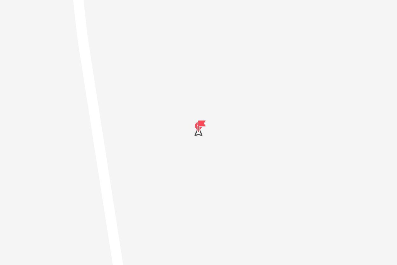 Una singola puntina rossa che segna una posizione su una mappa minimalista grigio chiaro.