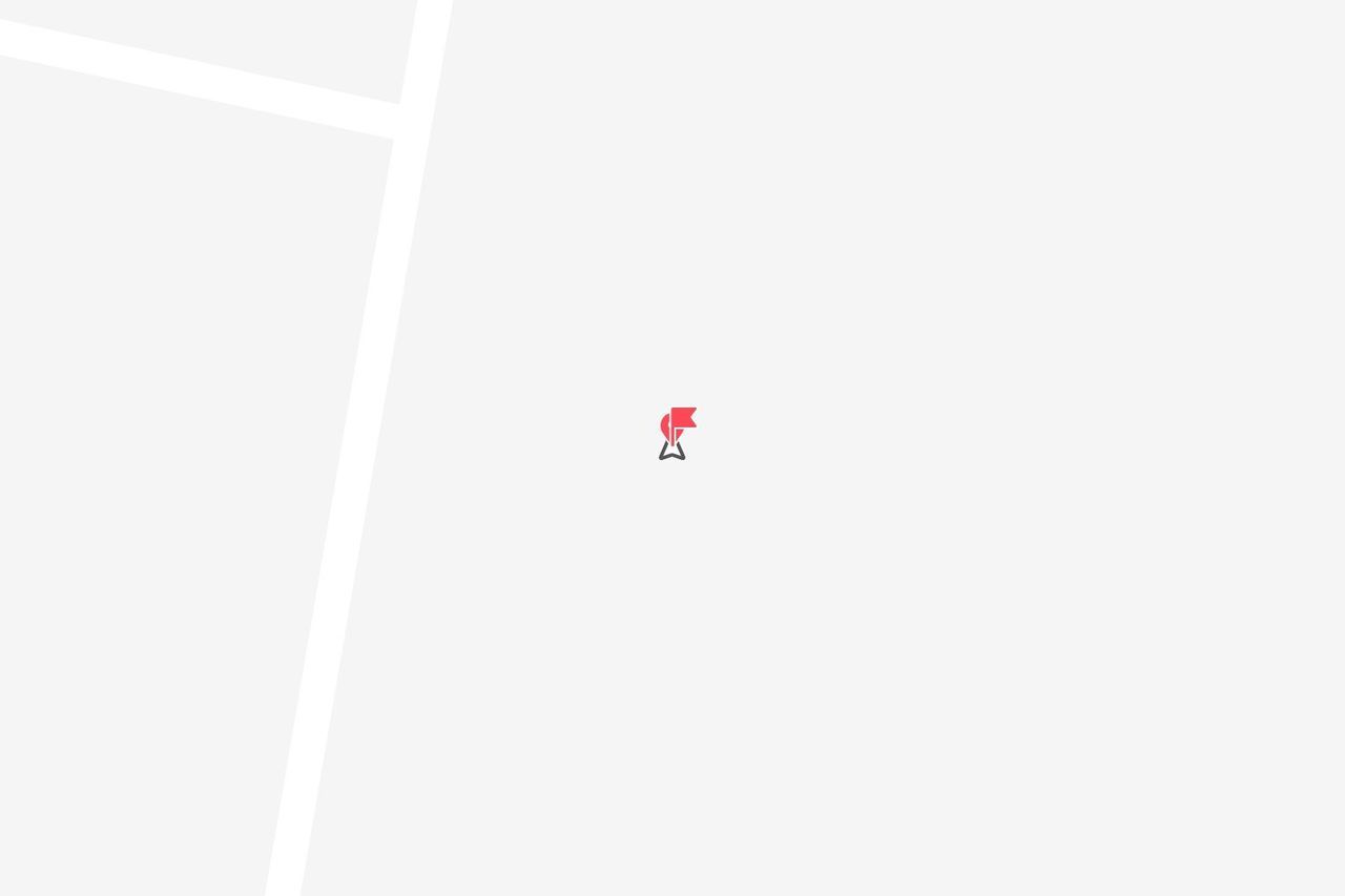 Un'icona di puntina rossa che indica una posizione su una mappa digitale minimalista con linee bianche a rappresentare le strade.