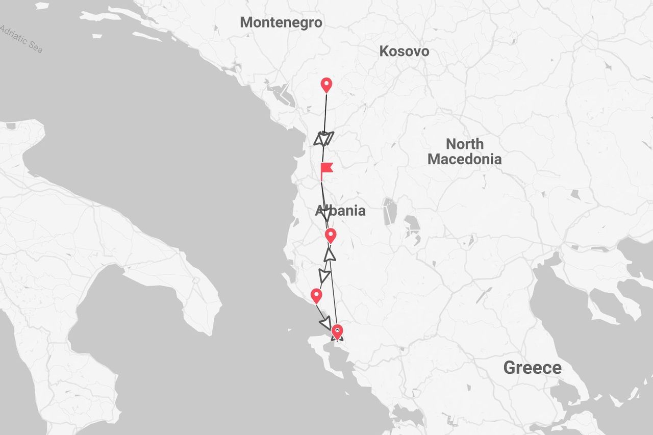 A map showing a travel route through Albania, marked with a line and red pins, from the northern border to the southern coast.