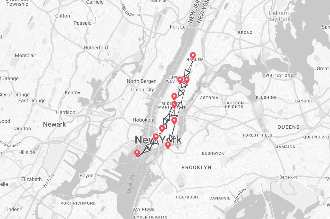 A black and white map of New York showing a travel itinerary with red pins and a black line through Manhattan.