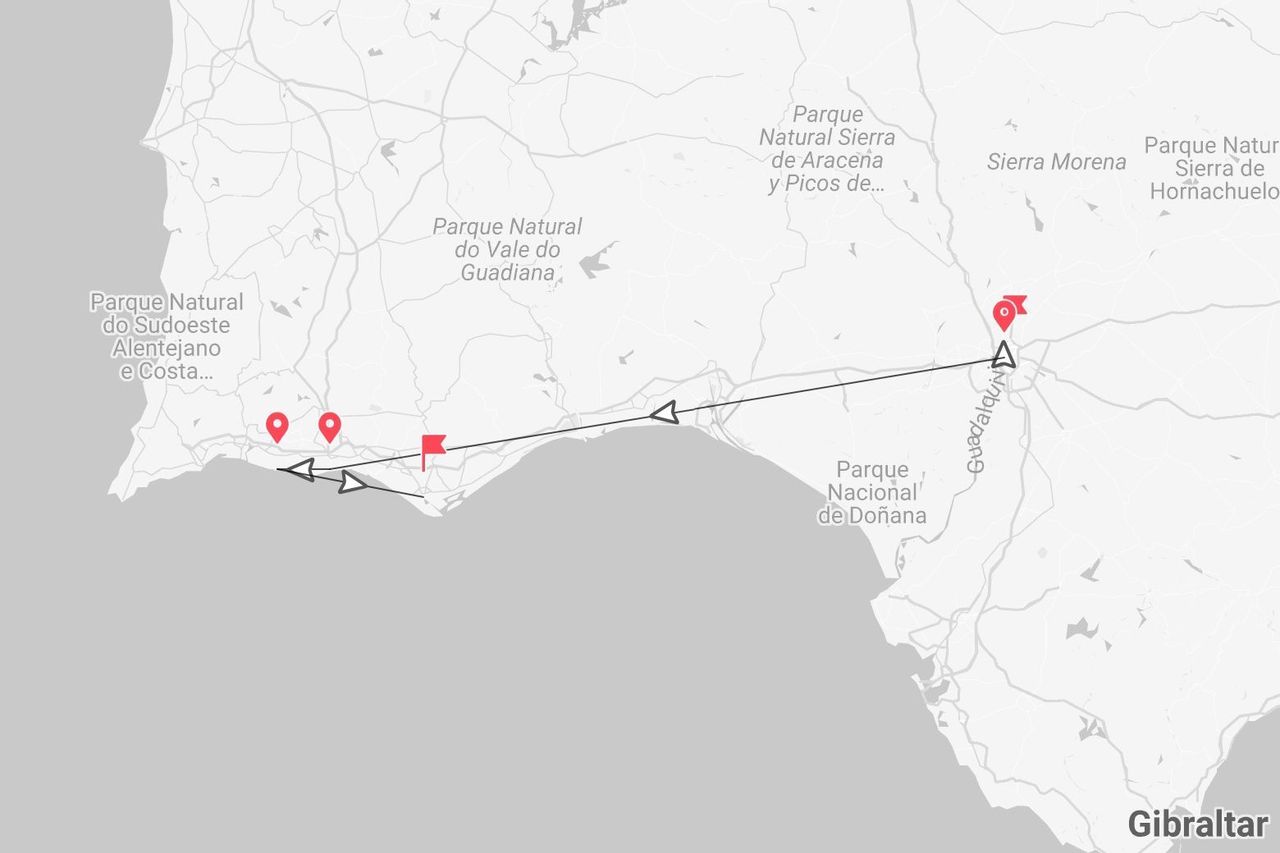 Una mappa che mostra un itinerario di viaggio lungo la costa meridionale di Portogallo e Spagna, passando vicino al Parco Nazionale di Doñana e al fiume Guadalquivir.