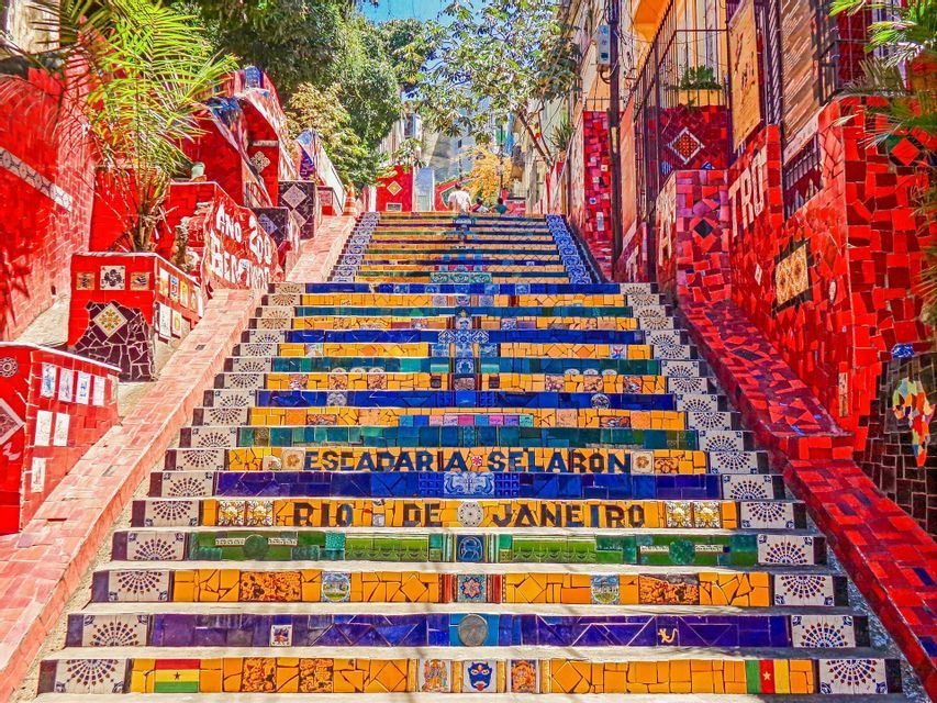 A low-angle view of the colorful mosaic-covered steps of the Escadaria Selarón in Rio de Janeiro.