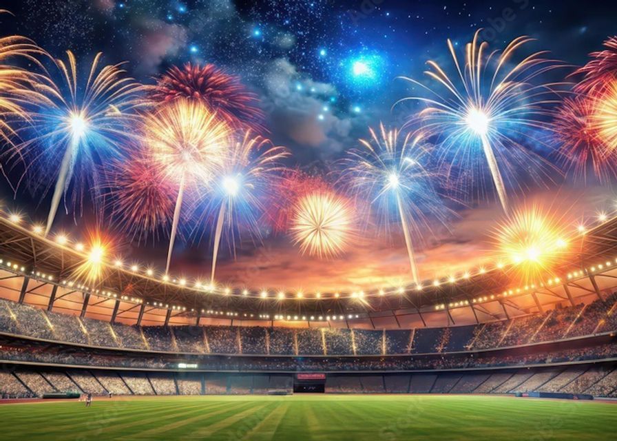 Colorful fireworks explode in a starry night sky above a crowded sports stadium with a green field.