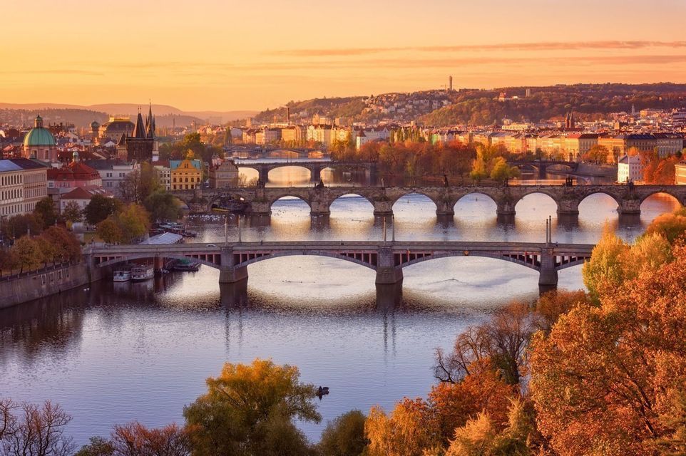 The bridges of Prague crossing the Vltava river on an autumn morning.