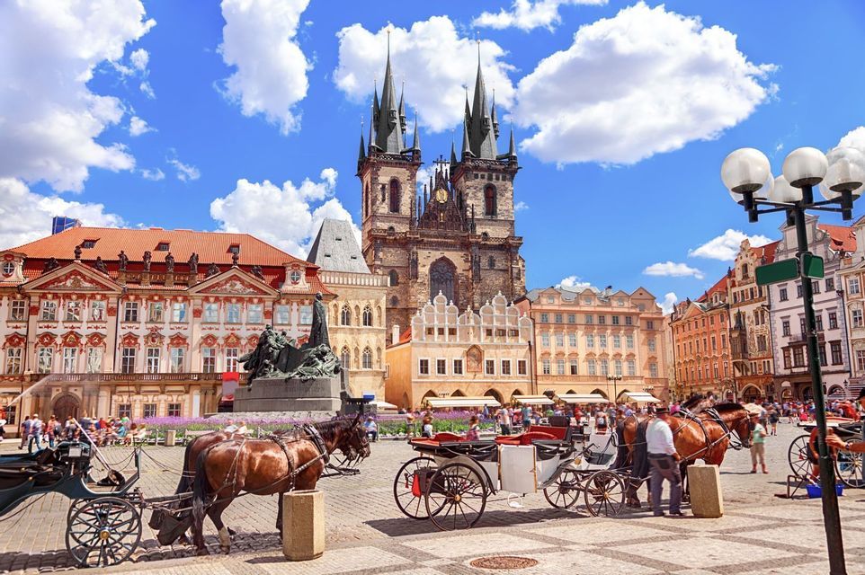 Horse-drawn carriages in Prague's Old Town Square in front of the Church of Our Lady before Tyn.
