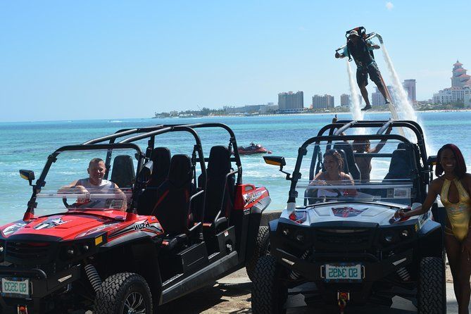 A WeRoad group trip with two off-road buggies at the beach, while a person on a flyboard levitates over the water.