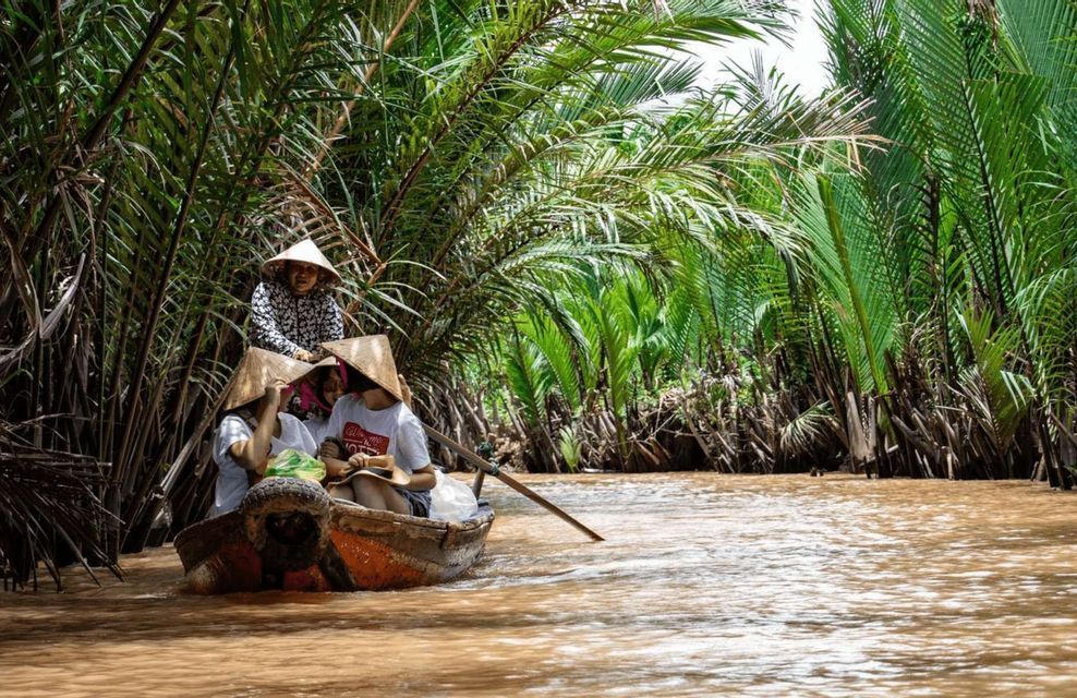 Mekong Delta canal A boat with conical hats along a canal in the Mekong Delta