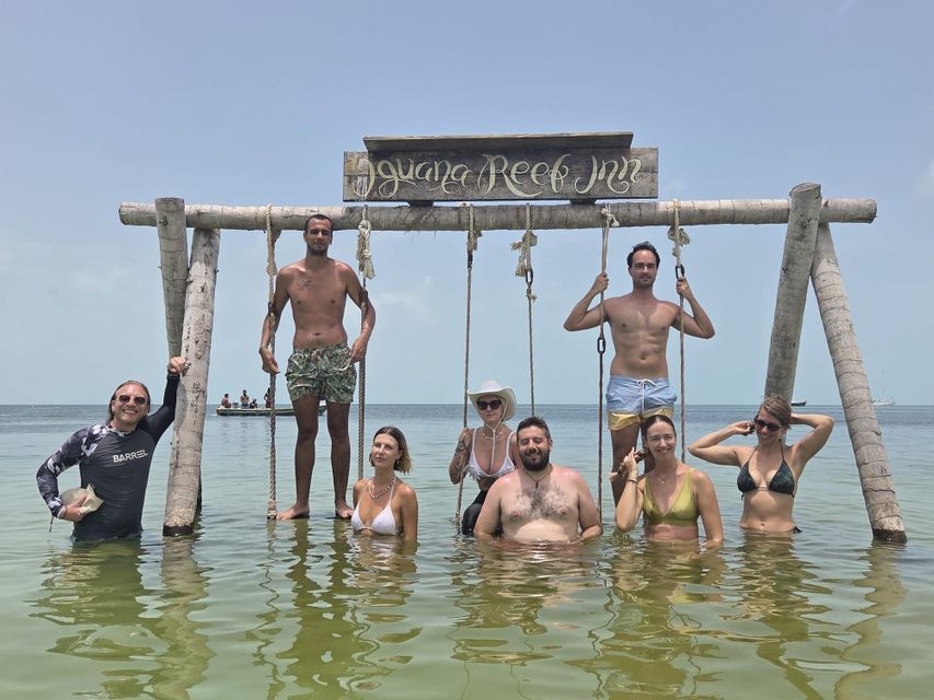 Iguana Reef swings Travelers on swings over the sea on Caye Caulker, Belize