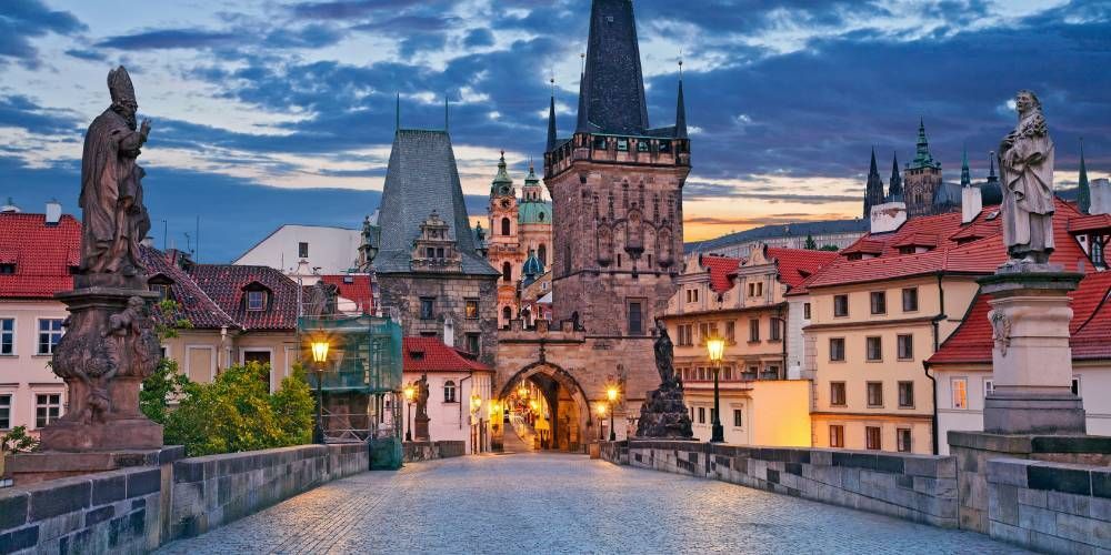 The Old Town bridge tower at the end of Charles Bridge in Prague at dawn.