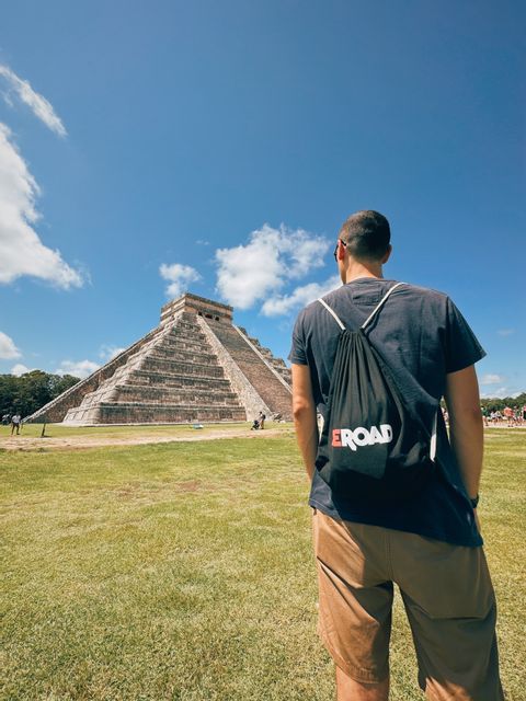 A man with a WeRoad rucksack watching at Chichen Itza - Mexico